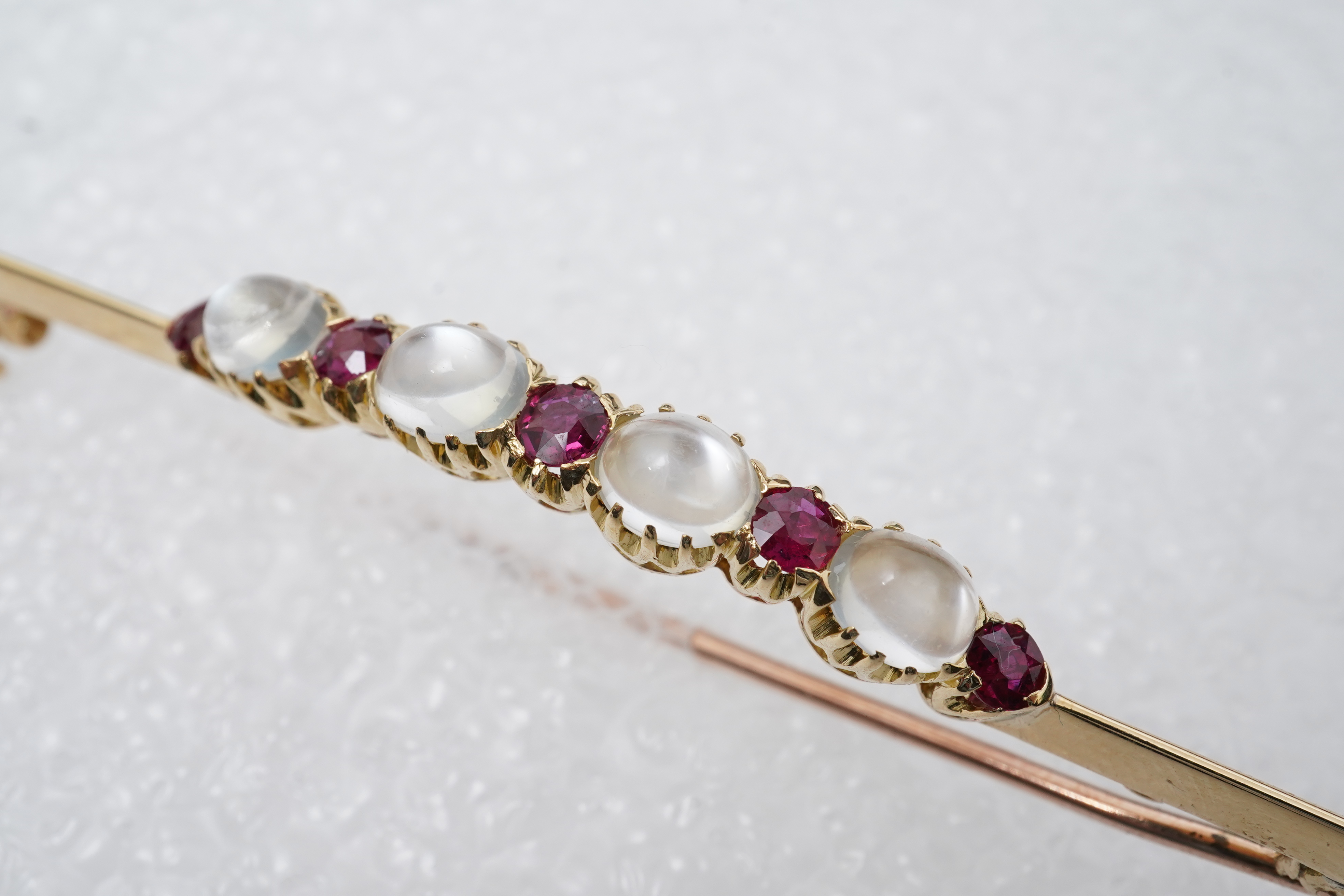 A moonstone and ruby brooch, circa 1900